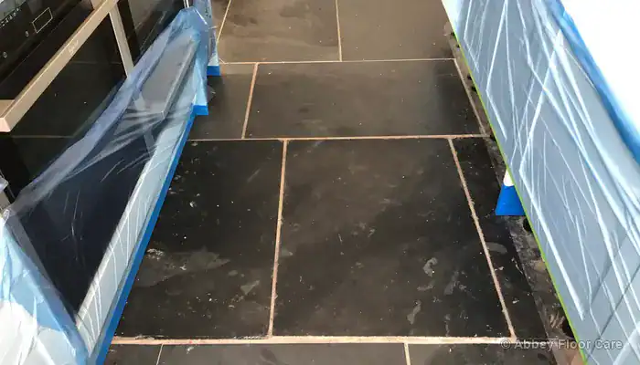 Slate floor test area showing different restoration needs