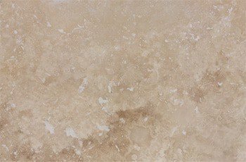 Front face of a travertine tile showing filled surface holes