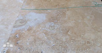 Filled travertine with grout haze ready to be smoothed