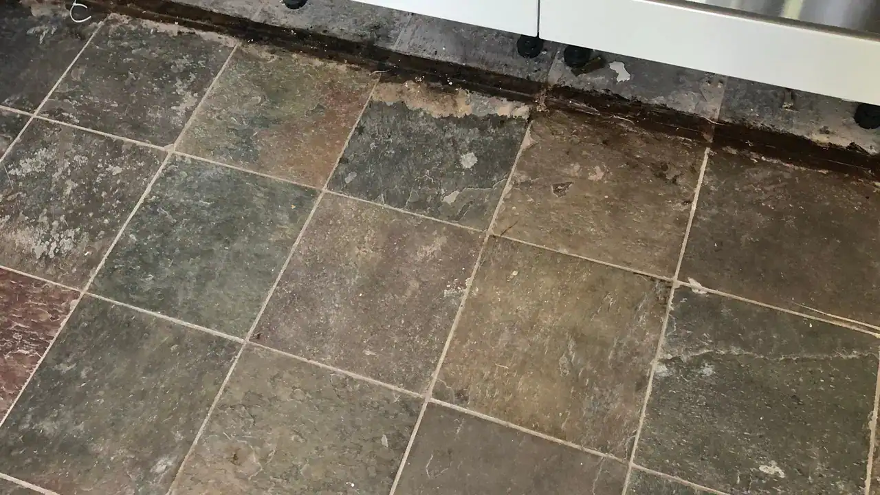 Worn slate floor showing the stages that separate cleaning, repair, sealing and restoration